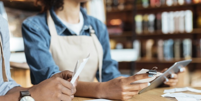 Restaurant employees reviewing receipts - Source National Restaurant Association